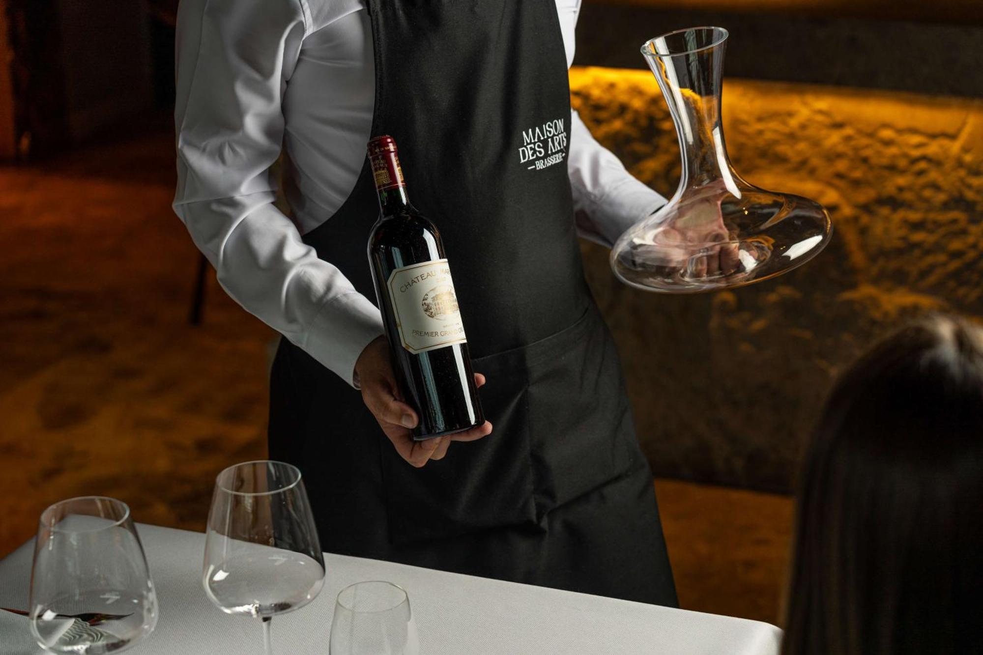 Radisson Blu Hotel Bucureşti Exterior foto Sommelier with a wine bottle and a decanter